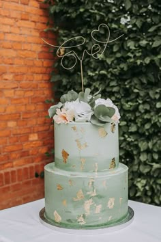 a green cake with white flowers on top