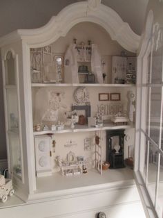 a doll house with all white furniture and accessories in it's display case,