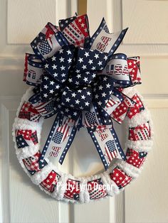 a patriotic wreath hanging on the front door