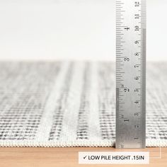 a measuring ruler sitting on top of a rug