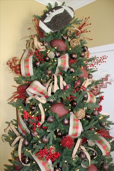 a christmas tree decorated with ornaments and bows