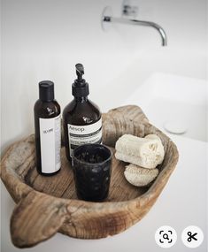 a bathroom sink with soap, lotion and hand sanitizer on it's tray