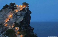 an image of a cliff with lights on it