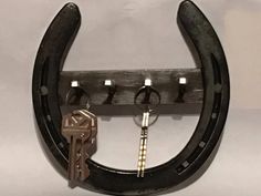 a horseshoe shaped key holder with keys hanging from it