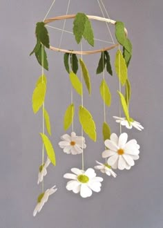 a mobile with flowers and leaves hanging from it