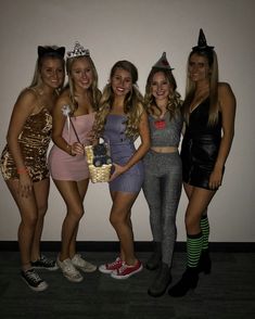 four women dressed up in costumes posing for the camera