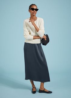 Description Slip skirts are enjoying a moment, and Doris is the easiest and most impactful style to update your wardrobe with. Crafted in satin-back crepe Ecojilin viscose, this style comes in a simple column shape, and features hidden elastic in the back of the waistband for comfort. In classic navy, it will add a considered twist to plain white tees or jumpers, and can easily be dressed-up with a blouse or camisole for nights out. Made in Europe Crafted in premium organic denim that holds its Blue Slip Skirt Outfit, Blue Slip Skirt, Plain White Tees, Satin Slip Skirt, Fancy Casual, Plain White T Shirt, Crew Neck Cardigan, Plain White Tee, Slip Skirts