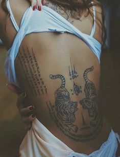 a woman with tiger tattoos on her back