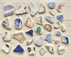 many different shapes and sizes of rocks on a wooden surface