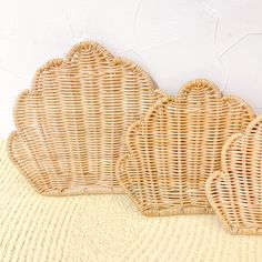 three wicker scallops are lined up on the floor next to each other