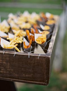 a table topped with lots of food on top of a wooden table covered in plastic wrappers