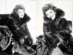 black and white photograph of woman in fur coat sitting on chair with legs crossed, smiling