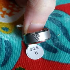 Sz 6. Multiple Superman Logos Adorn This Ring Superman Ring, Superman Logo, Stainless Steel Ring, Ring Color, Stainless Steel Rings, Steel Ring, Womens Jewelry Rings, Superman, Women Rings