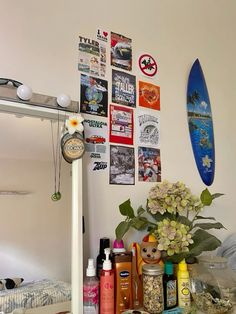 a surfboard is hanging on the wall next to various items