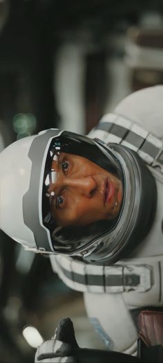 a close up of a person in a space suit with a helmet and goggles