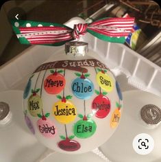 a glass ornament with the names of different countries on it and a bow