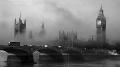 the big ben clock tower towering over the city of london on a foggy day