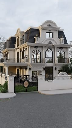 a large white house with lots of windows and balconies