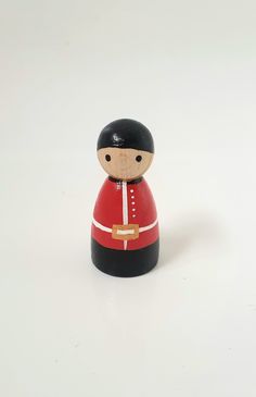 a small wooden toy soldier on a white background