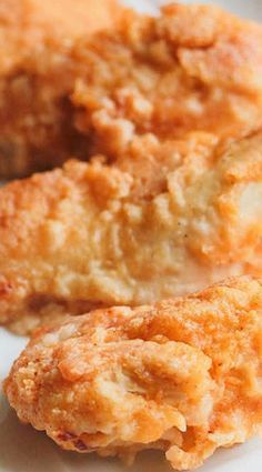 two fried chicken patties on a white plate