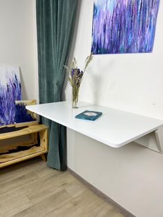 a white table with some purple flowers on it