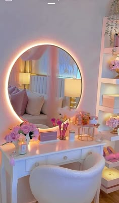 a white desk topped with a mirror next to a chair and table covered in pink flowers