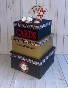 three boxes stacked on top of each other with playing cards and dices in them