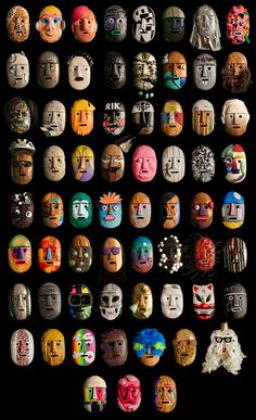 many different colored masks are arranged on a black background