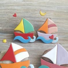 decorated cookies with boats on them sitting on top of a wooden table next to each other