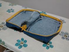 an open jean purse sitting on top of a table