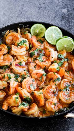 a skillet filled with shrimp and garnished with cilantro