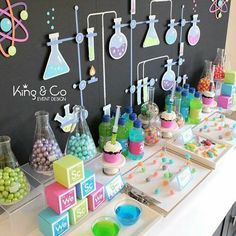 the table is full of colorful items for children's science class, including beakles and flasks