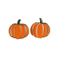 two orange pumpkins sitting next to each other