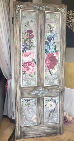 an old door with flowers painted on it