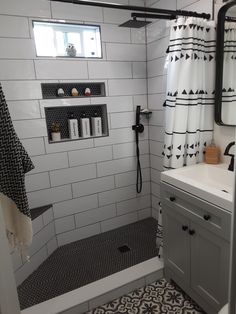 a white bathroom with black and white shower curtain