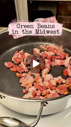 green beans in the middle of a frying pan on top of a stovetop