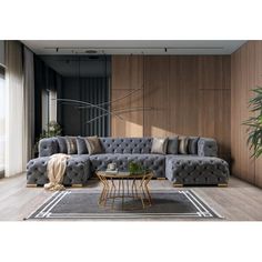 a living room filled with furniture next to a large window and potted plant on top of a wooden floor