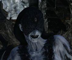 a creepy looking creature standing in front of a stone wall with ice on it's face