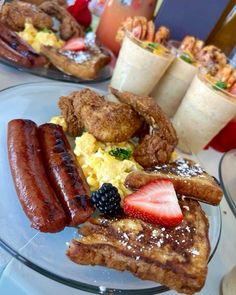 two plates with breakfast foods on them sitting on a table