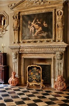 an ornate fireplace in the middle of a room with paintings on the wall above it