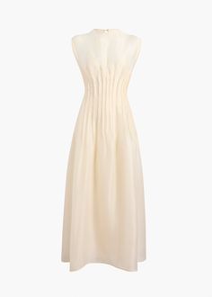 A sleeveless dress in shantung organza. Shaped by pintuck detailing at the waist. Covered buttons with grosgrain guard. Includes slip. Leather Outerwear, Ivory Dresses, Dress Crafts, Denim Shoes, Pin Tucks, Drop Waist, Outerwear Coats, Covered Buttons, Shirt Jacket