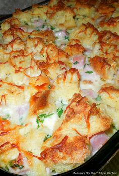 a casserole dish with cheese and spinach in it on a pink background