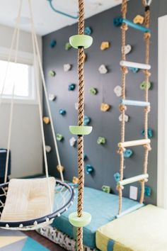 a child's bedroom with climbing ropes and toys