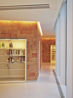 an empty room with bookshelves and shelves on the wall in front of it