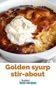 a close up of a casserole in a bowl with whipped cream on top