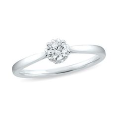 a white gold engagement ring with a diamond center