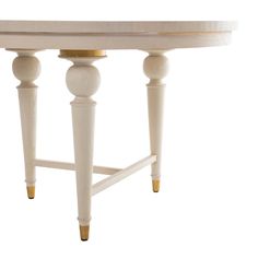 a white table with two wooden legs and an oval shaped top, against a white background