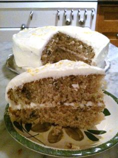 a slice of cake on a plate with the rest of the cake in the background