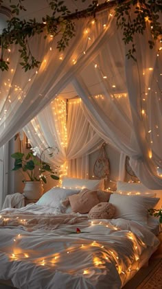 a bed with white sheets and lights on it