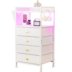 a white dresser with pink lights and headphones on top